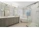Bright bathroom with double vanity, soaking tub, and glass-enclosed shower at 1119 Glenridge Pl, Atlanta, GA 30342