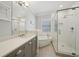 Bright bathroom with soaking tub and glass-enclosed shower and stone countertop vanity at 1119 Glenridge Pl, Atlanta, GA 30342