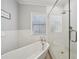 Elegant soaking tub and glass enclosed shower in a bright and luxurious bathroom at 1119 Glenridge Pl, Atlanta, GA 30342