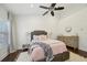 Charming bedroom with a ceiling fan, bedside tables, and a stylish dresser at 1119 Glenridge Pl, Atlanta, GA 30342