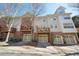 Beautiful multi-level townhome featuring brick accents, private decks, and individual garages at 1119 Glenridge Pl, Atlanta, GA 30342