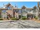 Beautiful townhome exteriors with brick and stone accents and manicured landscaping at 1119 Glenridge Pl, Atlanta, GA 30342