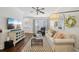 Cozy living room featuring hardwood floors, a ceiling fan, and bright natural light at 1119 Glenridge Pl, Atlanta, GA 30342