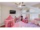 Playful bedroom design features a house frame bed, a pink tent, and colorful decor at 1312 Woodland View Rd, Lawrenceville, GA 30043