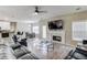 Open-concept living area featuring a fireplace, ceiling fan, and access to the backyard at 1312 Woodland View Rd, Lawrenceville, GA 30043
