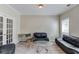 Bright living room with neutral paint, french doors and stylish furniture at 1312 Woodland View Rd, Lawrenceville, GA 30043