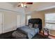 Main bedroom features tray ceiling, lots of natural light, a dark accent wall and hardwood floors at 1312 Woodland View Rd, Lawrenceville, GA 30043