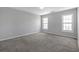 Bedroom with neutral carpet, gray walls, a ceiling fan and two windows at 145 Silver Mine Trl, Austell, GA 30168