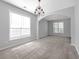 Inviting living room featuring an archway, chandelier and neutral walls, bathed in natural light at 145 Silver Mine Trl, Austell, GA 30168