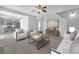 Open living room with neutral colors, modern furnishings and great view of the kitchen, bathed in natural light at 145 Silver Mine Trl, Austell, GA 30168