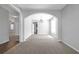 Spacious room with neutral walls and an arched doorway leading to the dining area, bathed in natural light at 145 Silver Mine Trl, Austell, GA 30168