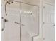 Modern bathroom with a glass-enclosed shower and grab bars at 2565 Grapevine Cir # 103, Cumming, GA 30041