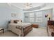 Bedroom with light blue walls, tray ceiling and carpeted floor at 2565 Grapevine Cir # 103, Cumming, GA 30041