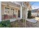 Inviting front porch with seating, decorative wreath, brick accents, and pleasant curb appeal at 2565 Grapevine Cir # 103, Cumming, GA 30041