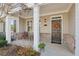 Charming covered porch with a cozy seating area and a decorative wreath on the front door at 2565 Grapevine Cir # 103, Cumming, GA 30041