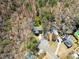 An aerial view of a home surrounded by mature trees, showcasing its secluded setting and neighborhood at 400 Surveyors Pt, Suwanee, GA 30024