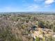 Overhead shot of a neighborhood community featuring mature trees, well-maintained homes, and attractive landscaping at 400 Surveyors Pt, Suwanee, GA 30024