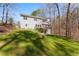 Expansive backyard featuring a well-maintained lawn, mature trees, and a multi-level deck, ideal for outdoor living at 400 Surveyors Pt, Suwanee, GA 30024