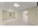 Finished basement area with tile ceiling, recessed lighting, beige walls, and access to another room at 400 Surveyors Pt, Suwanee, GA 30024