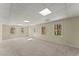 Large basement area with several windows and a door to the outside at 400 Surveyors Pt, Suwanee, GA 30024