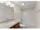 Bathroom with a granite countertop vanity and a shower-tub combo at 400 Surveyors Pt, Suwanee, GA 30024