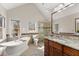 Bright bathroom featuring a soaking tub, double vanities, granite countertops, and a glass enclosed shower at 400 Surveyors Pt, Suwanee, GA 30024