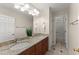 Bathroom featuring double sinks, granite countertops, and an adjoining toilet and shower room at 400 Surveyors Pt, Suwanee, GA 30024