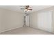 Bright bedroom with a neutral color palette and plush carpeting, plus a glimpse into the en-suite bathroom at 400 Surveyors Pt, Suwanee, GA 30024