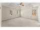 Spacious bedroom featuring neutral carpeting, neutral paint and a ceiling fan at 400 Surveyors Pt, Suwanee, GA 30024