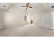 Spacious bedroom featuring a tray ceiling, ceiling fan, neutral color palette, and plush carpeting at 400 Surveyors Pt, Suwanee, GA 30024