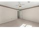 A neutral toned bedroom is equipped with a ceiling fan, light carpeting and baseboard trim at 400 Surveyors Pt, Suwanee, GA 30024