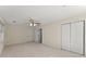 A bright bedroom with neutral paint, light carpeting, a ceiling fan, and a double-door closet at 400 Surveyors Pt, Suwanee, GA 30024