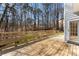 Spacious wooden deck with built-in bench seating, offering a relaxing outdoor space with views of the surrounding greenery at 400 Surveyors Pt, Suwanee, GA 30024