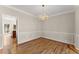 Formal dining room featuring hardwood floors and chair rail plus a decorative light fixture at 400 Surveyors Pt, Suwanee, GA 30024