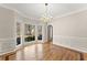 Dining room with a bay window, hardwood floors and decorative lighting at 400 Surveyors Pt, Suwanee, GA 30024