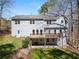 Back exterior view showcasing a large deck, patio, and well-manicured lawn, perfect for entertaining outdoors at 400 Surveyors Pt, Suwanee, GA 30024