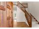 Spacious entryway features wood floors and a staircase with wood railing at 400 Surveyors Pt, Suwanee, GA 30024