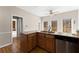 Bright kitchen features wood floors and cabinets, granite countertops, and stainless steel appliances at 400 Surveyors Pt, Suwanee, GA 30024