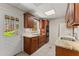 Kitchenette with wooden cabinets, granite countertops, and stainless-steel sink at 400 Surveyors Pt, Suwanee, GA 30024
