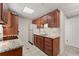 Kitchenette with dark wood cabinets and granite countertops at 400 Surveyors Pt, Suwanee, GA 30024
