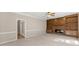 Spacious living room with built-in shelving, a stone fireplace and a ceiling fan at 400 Surveyors Pt, Suwanee, GA 30024