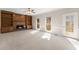 Bright living room features a fireplace with wood mantle and built in shelving plus exterior access to a deck at 400 Surveyors Pt, Suwanee, GA 30024