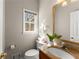 Well-lit powder room with granite counters, decorative mirror and a sink at 400 Surveyors Pt, Suwanee, GA 30024