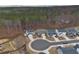 An aerial view of a neighborhood surrounded by lush trees, showcasing a serene environment at 5 Dew Drop Pt, Dallas, GA 30157