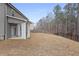 Spacious backyard with covered patio, privacy fence, and lush greenery at 5 Dew Drop Pt, Dallas, GA 30157