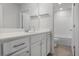 Bright bathroom featuring a single sink vanity, white cabinetry, and an adjacent toilet at 5 Dew Drop Pt, Dallas, GA 30157