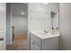 Bathroom featuring a vanity with a white countertop, chrome faucet, and glass shelving at 5 Dew Drop Pt, Dallas, GA 30157