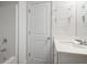 Bathroom with white vanity, tub, and glass shelving at 5 Dew Drop Pt, Dallas, GA 30157