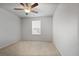 This bedroom includes neutral walls, carpet, a ceiling fan, and a window at 5 Dew Drop Pt, Dallas, GA 30157