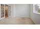 Neutral bedroom with carpet flooring, white walls, window with blinds and open french doors at 5 Dew Drop Pt, Dallas, GA 30157